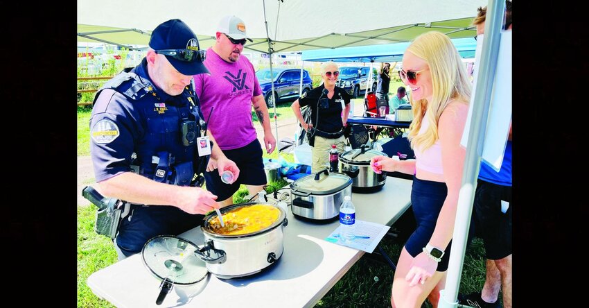 Elizabeth Police Department Chief Jeff Engel serves chili on Sept. 9 at the 6th Annual Protectors of Elizabeth and Elizabeth Fire Community Foundation’s Chili Cook-Off and Roasting Event in Running Creek Park. Credit: