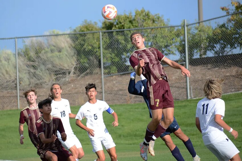 Golden senior Nic Friedman gets up for a header off a corner kick by the Demons during the first half Wednesday, Sept. 20, at the North Area Athletic Complex. The Demons defeated Dakota Ridge 6-0 in the Class 4A Jeffco League opener.